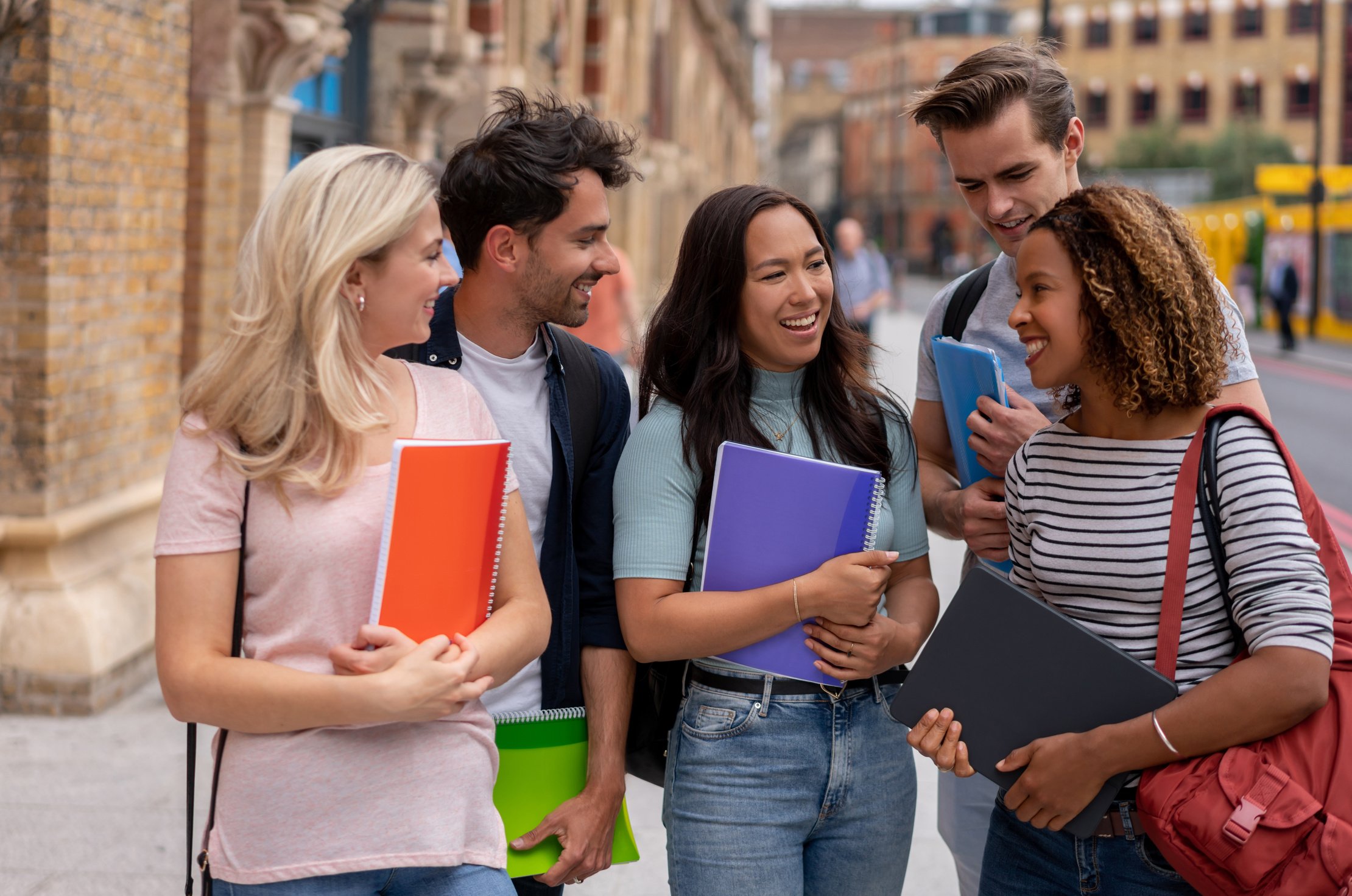 Happy group of students studying abroad in London